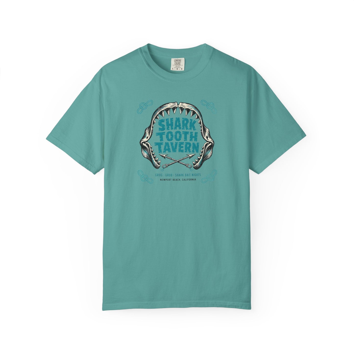 "Shark Tooth Tavern" — Newport Beach, California. Two inks, black and turquoise: a stylized shark-jaw arc with jagged carved teeth framing the venue name in bold tiki-block lettering, crossed harpoons...